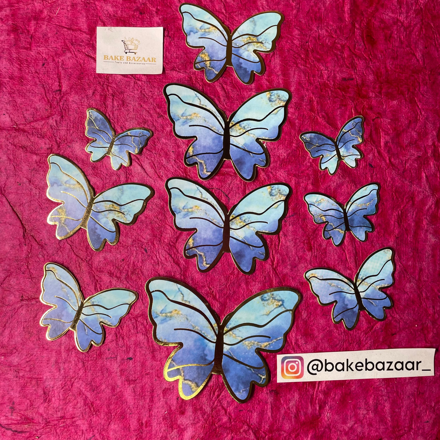Butterfly-shaped cookies on a pink surface with 'bakebazaar' branding.