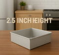 Square metal baking pan on a wooden kitchen counter with text indicating height.