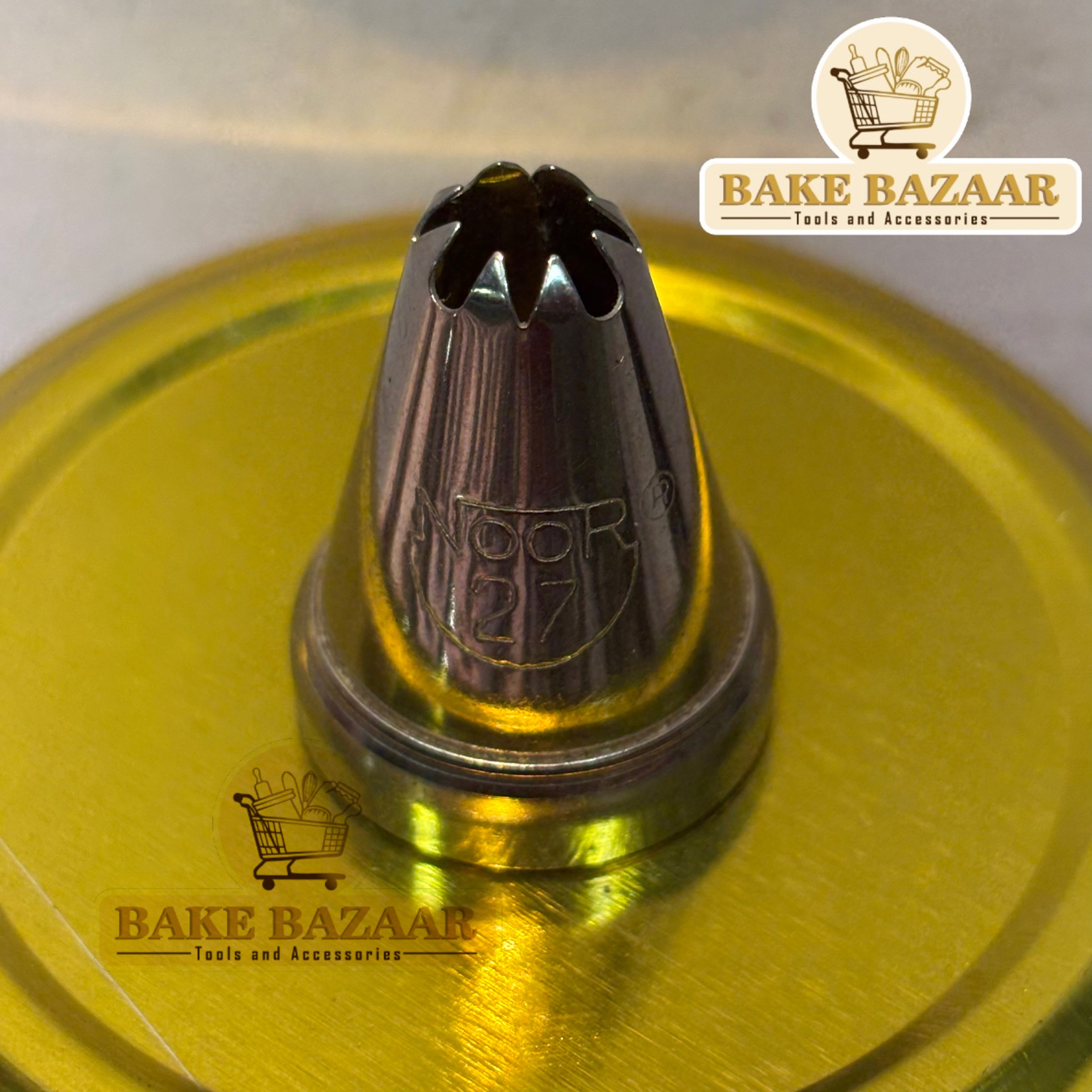 Metallic baking tool with 'Bake Bazaar' branding on a yellow background