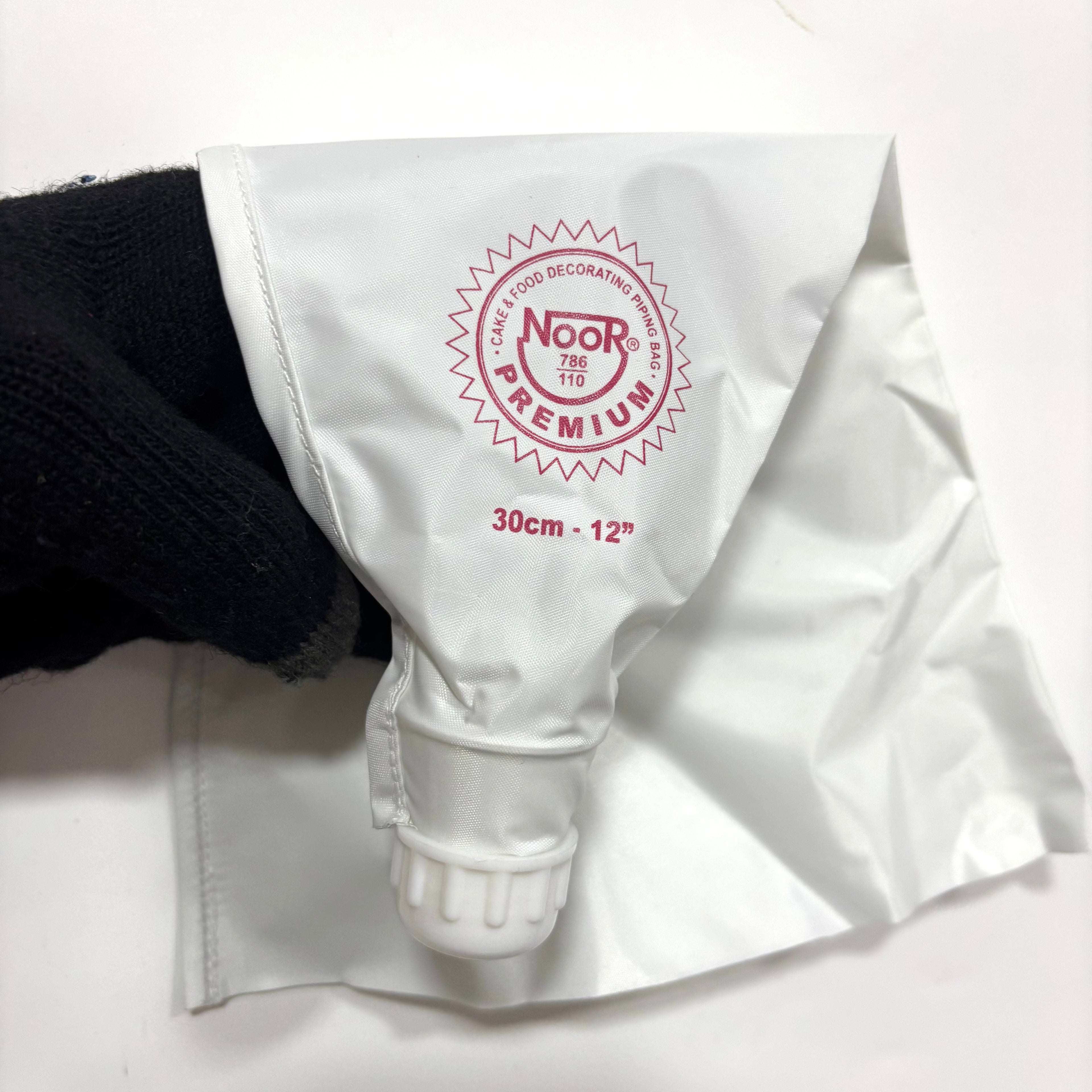 White piping bag with 'Noor Premium' branding on a white background
