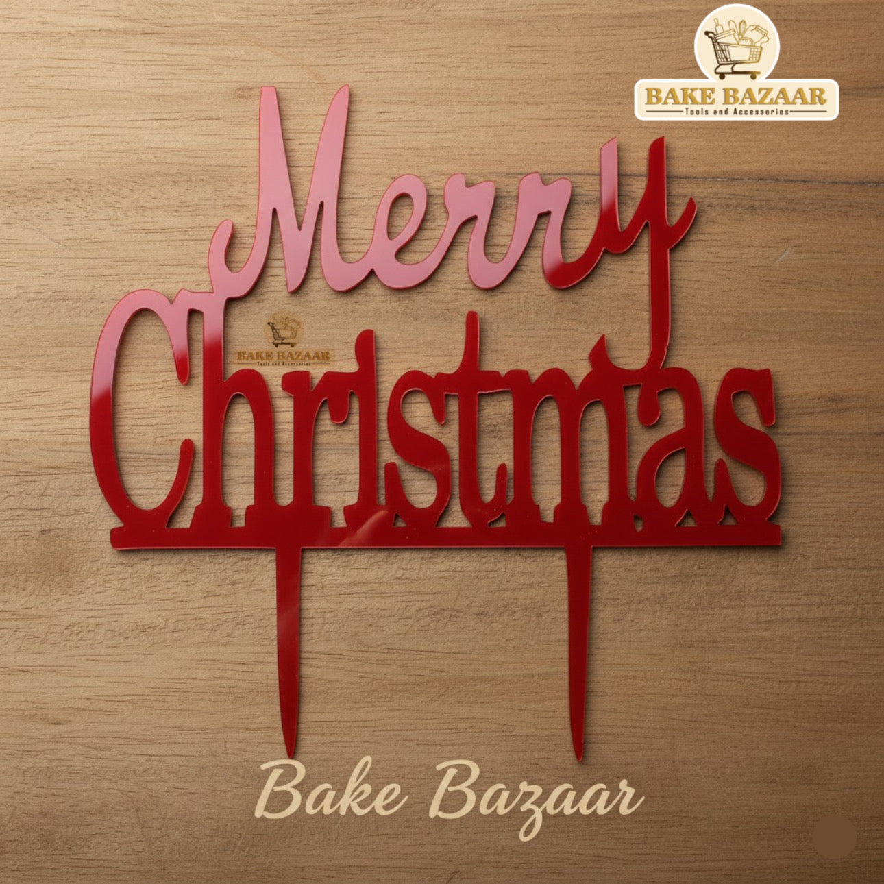 Red 'Merry Christmas' sign with Bake Bazaar logo on a wooden background