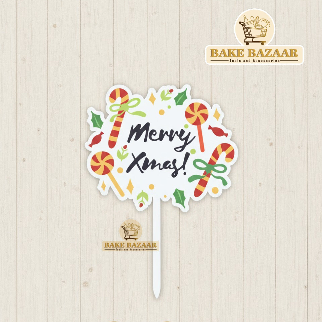 Christmas-themed cake topper with candy cane designs on a wooden background, branded 'Bake Bazaar'.
