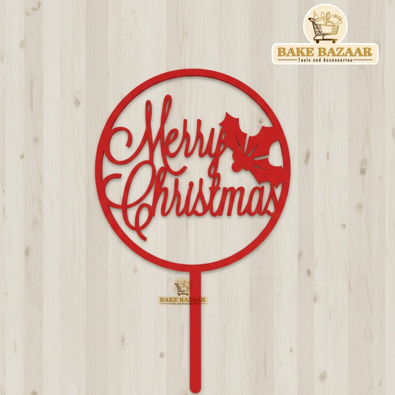 Red 'Merry Christmas' decorative piece on a wooden background with Bake Bazaar branding.