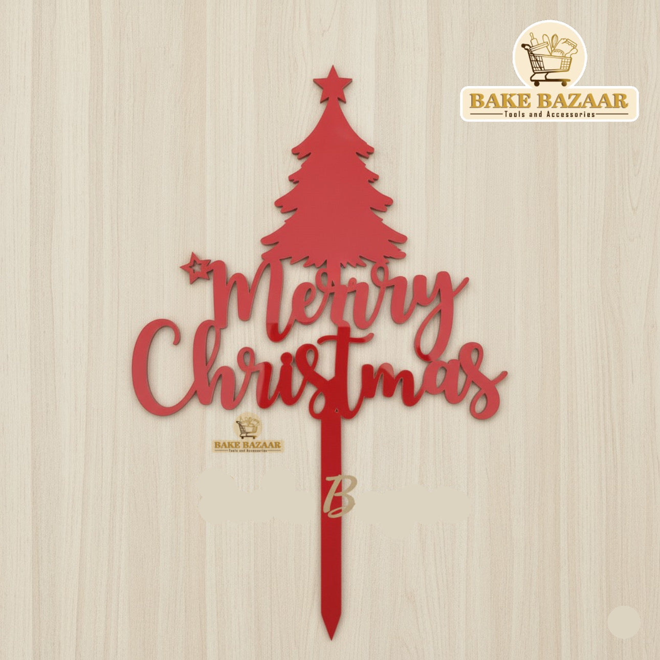 Red 'Merry Christmas' tree decoration with 'Bake Bazaar' branding on a beige background