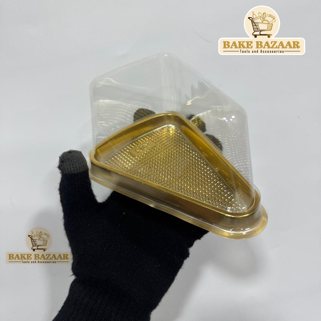 Gold-colored baking tray with a textured surface held by a gloved hand against a white background, branded 'Bake Bazaar'.