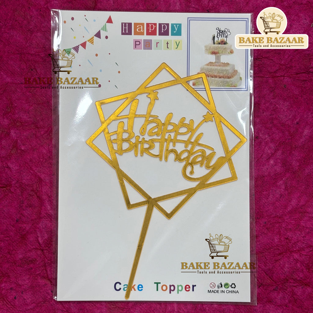 Gold 'Happy Birthday' cake topper packaging on a pink background