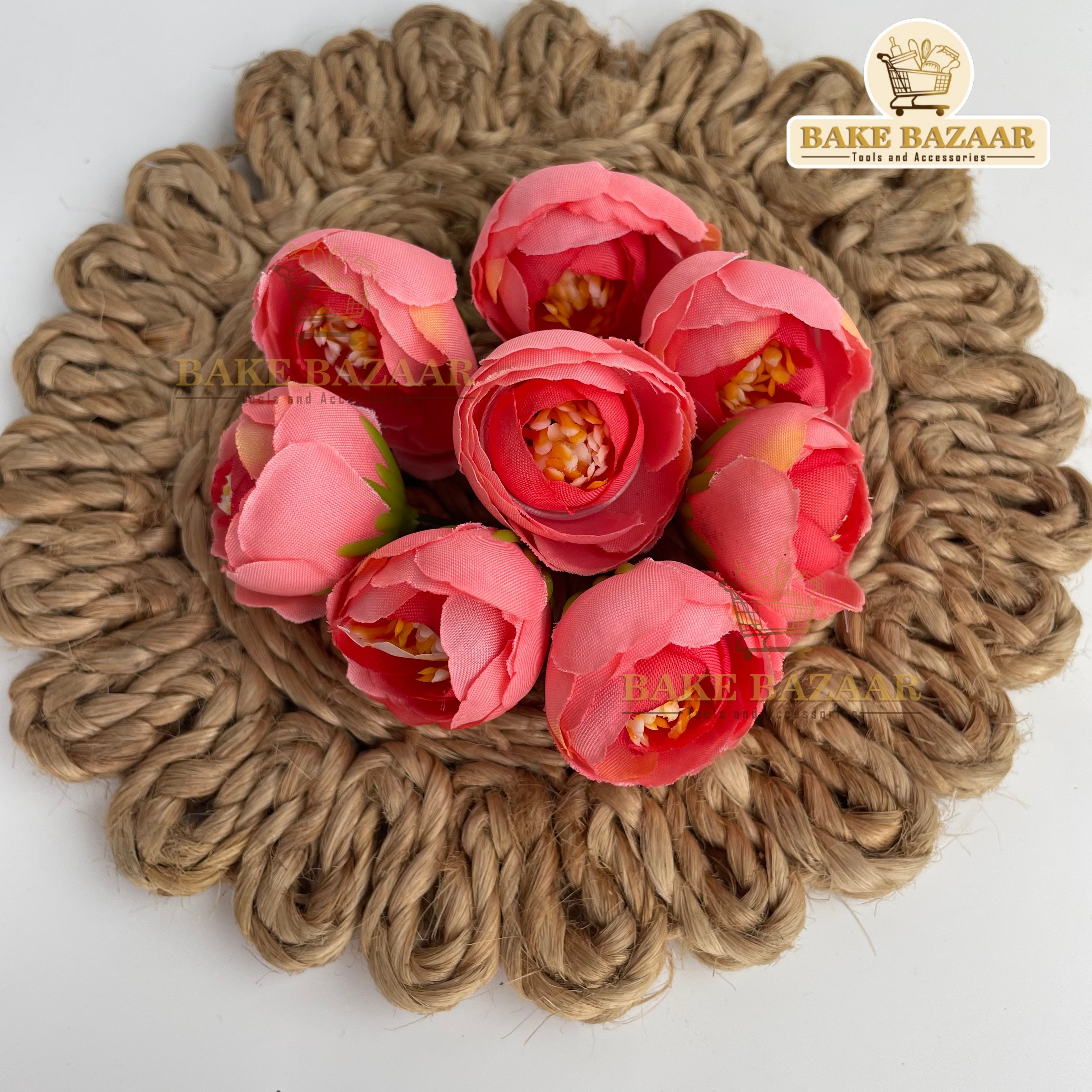 Pink flowers on a jute placemat with 'Bake Bazaar' branding.
