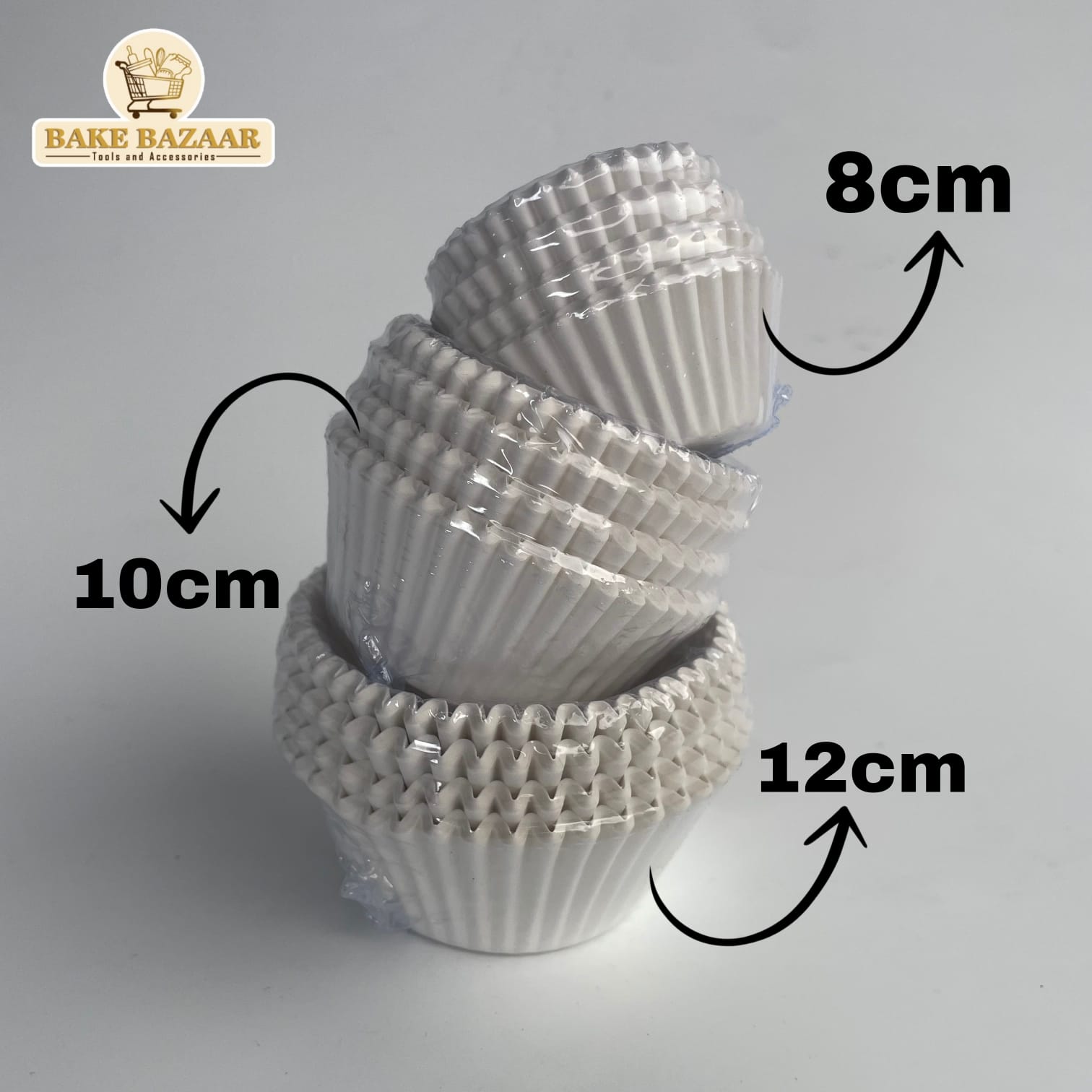 Stack of white cupcake liners with measurements on a gray background, featuring the Bake Bazaar brand.