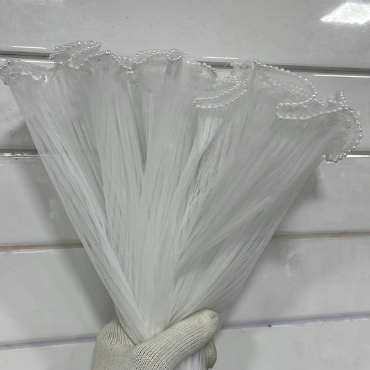 Hand holding a bundle of clear plastic straws against a white background